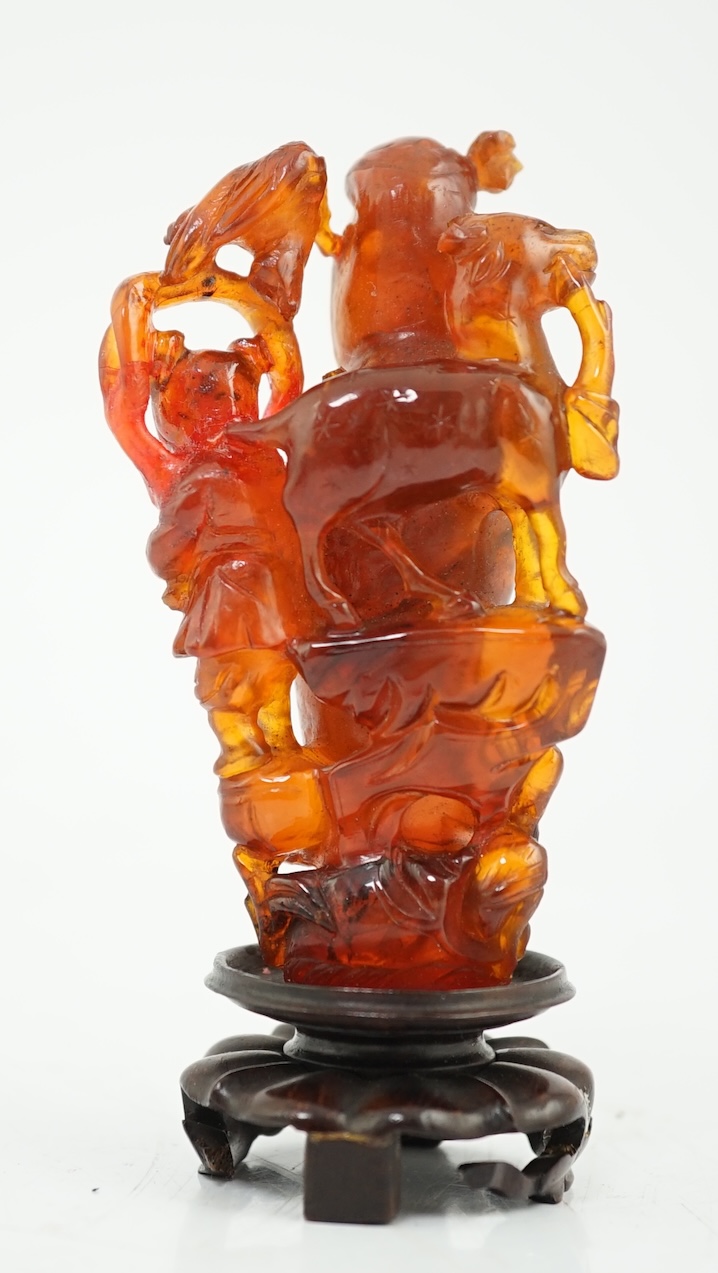 A Chinese amber group of Guanyin, 19th century, small losses